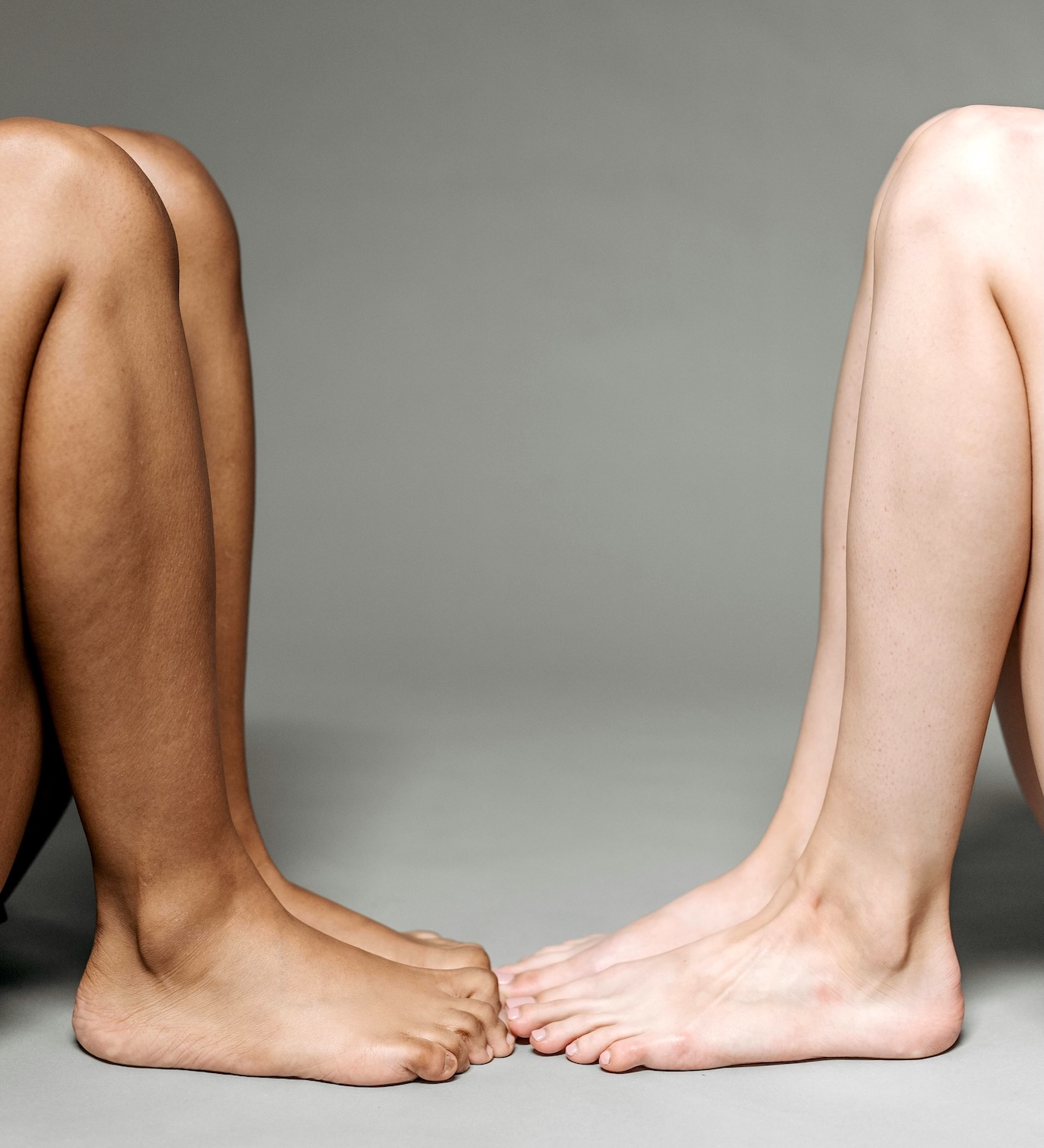 Photo of two people facing each other with only knees and feet visible